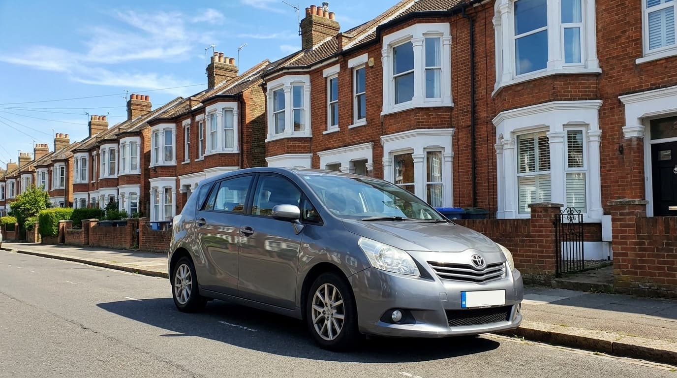 A grey Toyota Verso MPV parked on a terraced UK street
